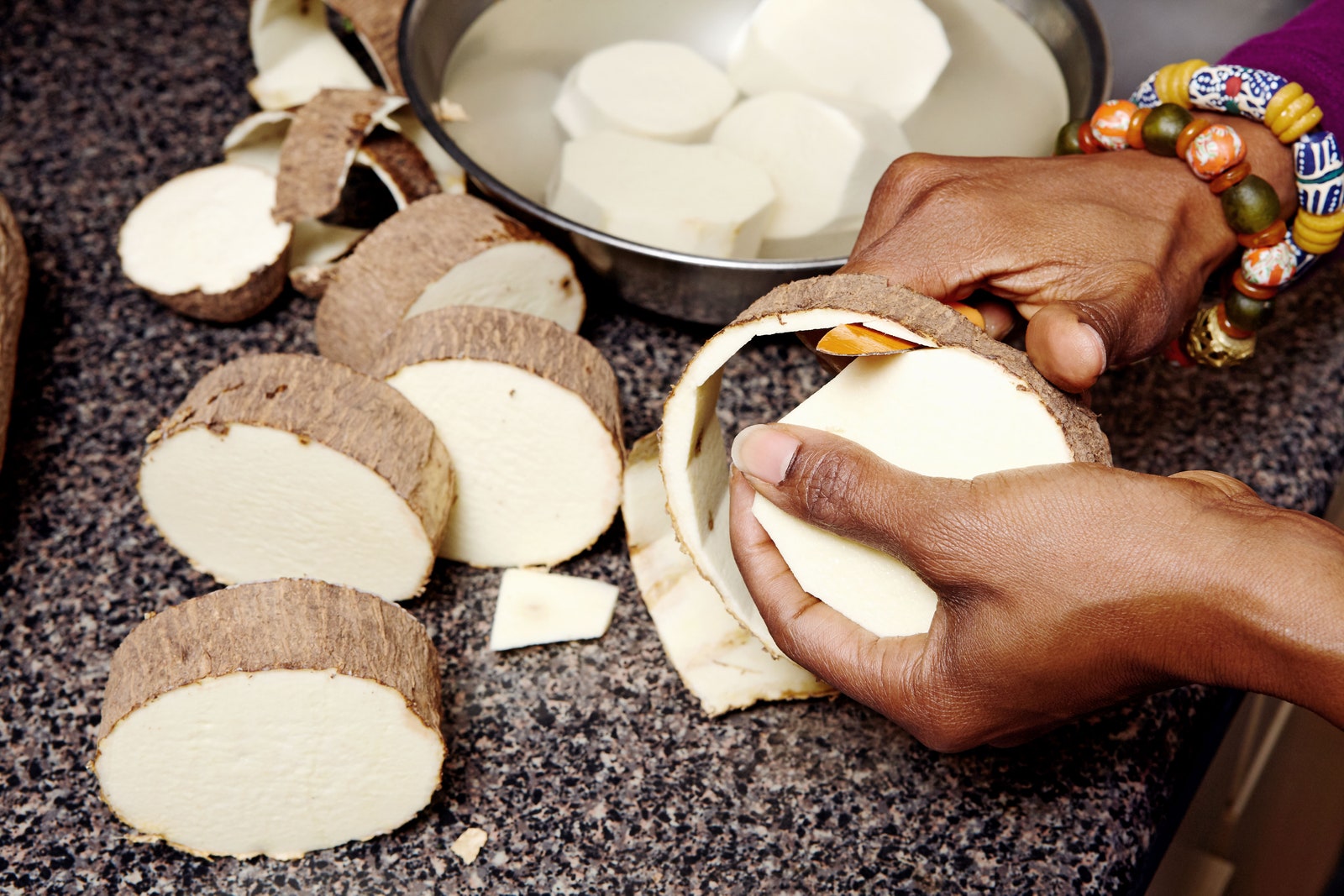 Photo of Kemi Seriki peeling yams.