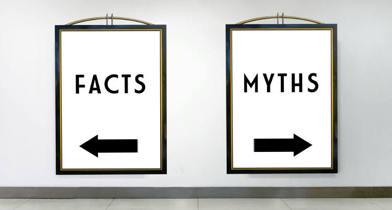 Two signs on a wall. One says facts and points left. The other says myths and points right.