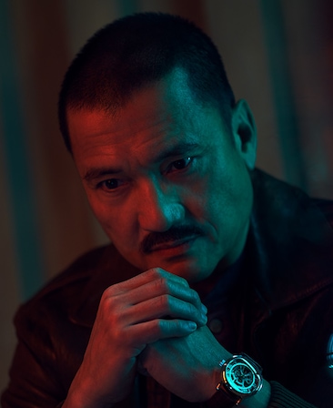 Jon Jon Briones sitting with his hands clasped together for FX's Class of '09