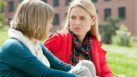 Mother and daughter talking outside