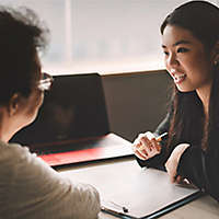 Active senior woman having discussion with agent about her retirement investment plan