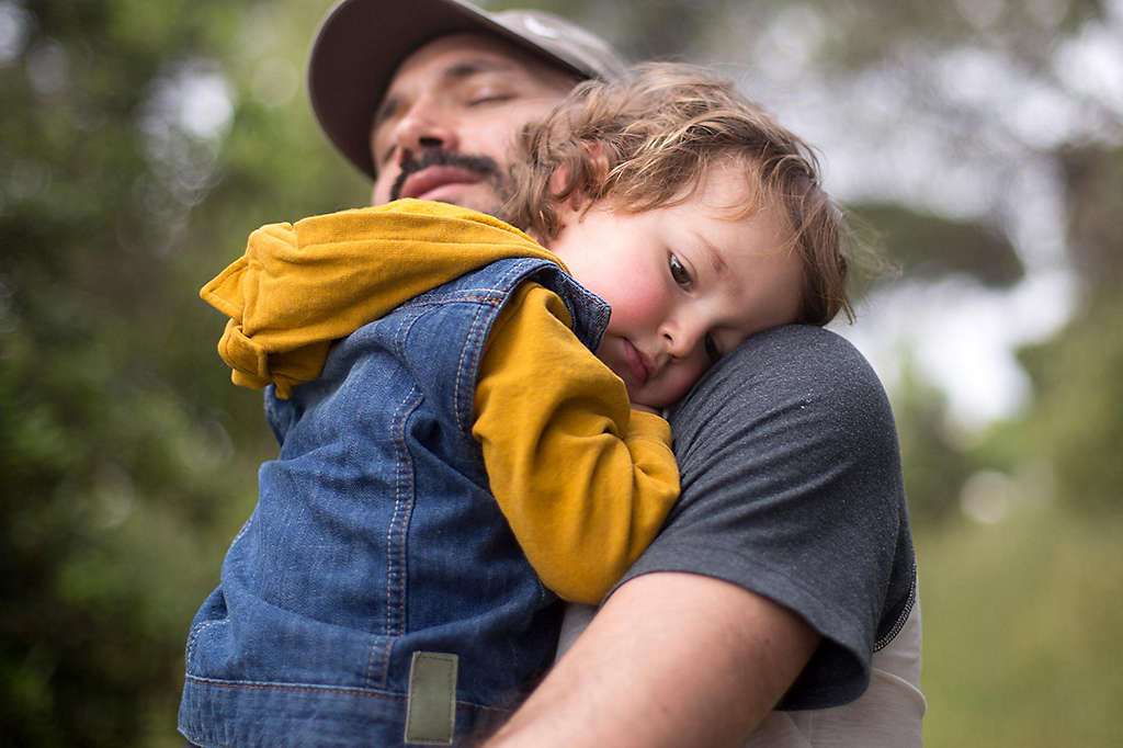 Father holding young son