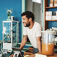 A man behind the counter at a health food restaurant.