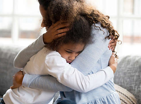 Parent and child hugging