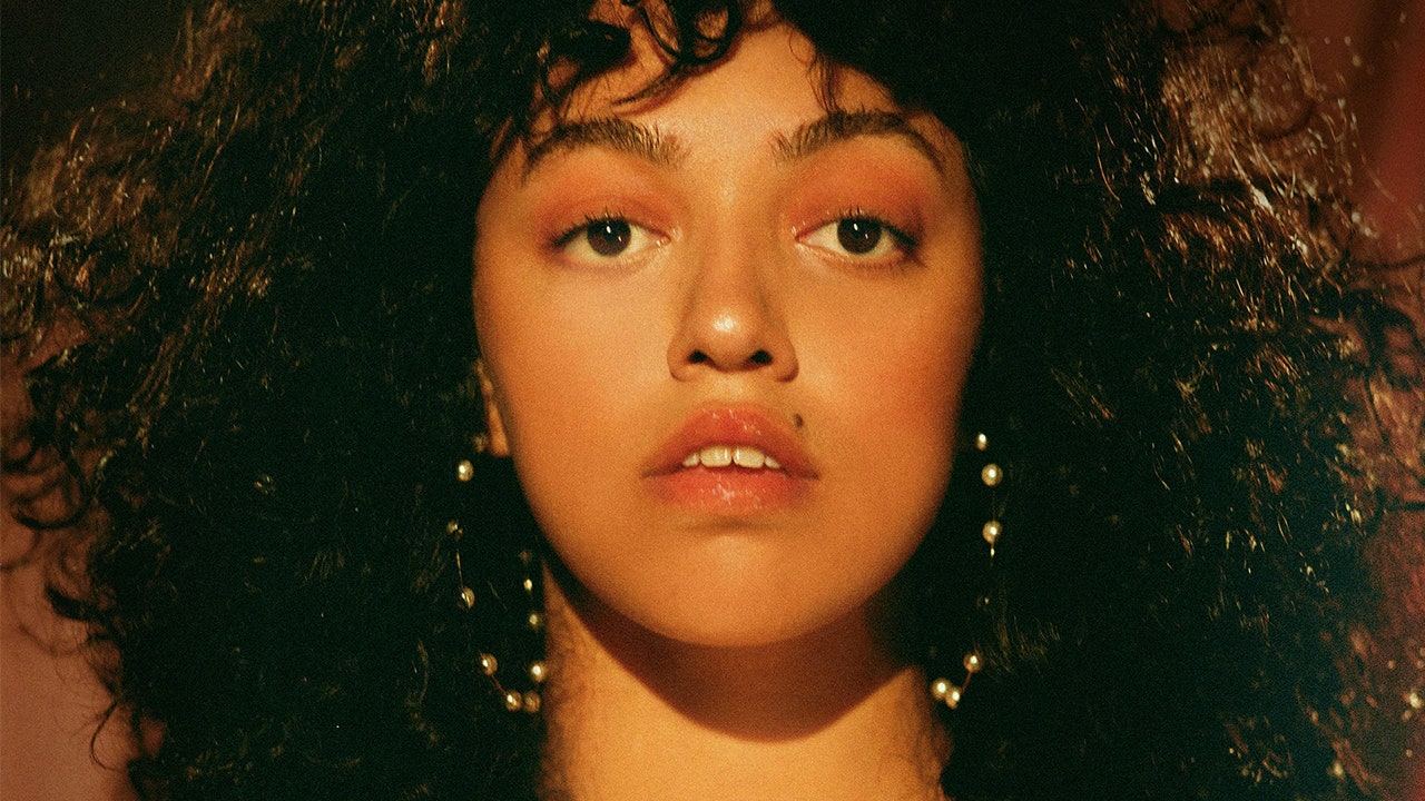 This image contains British singer Mahalia's face