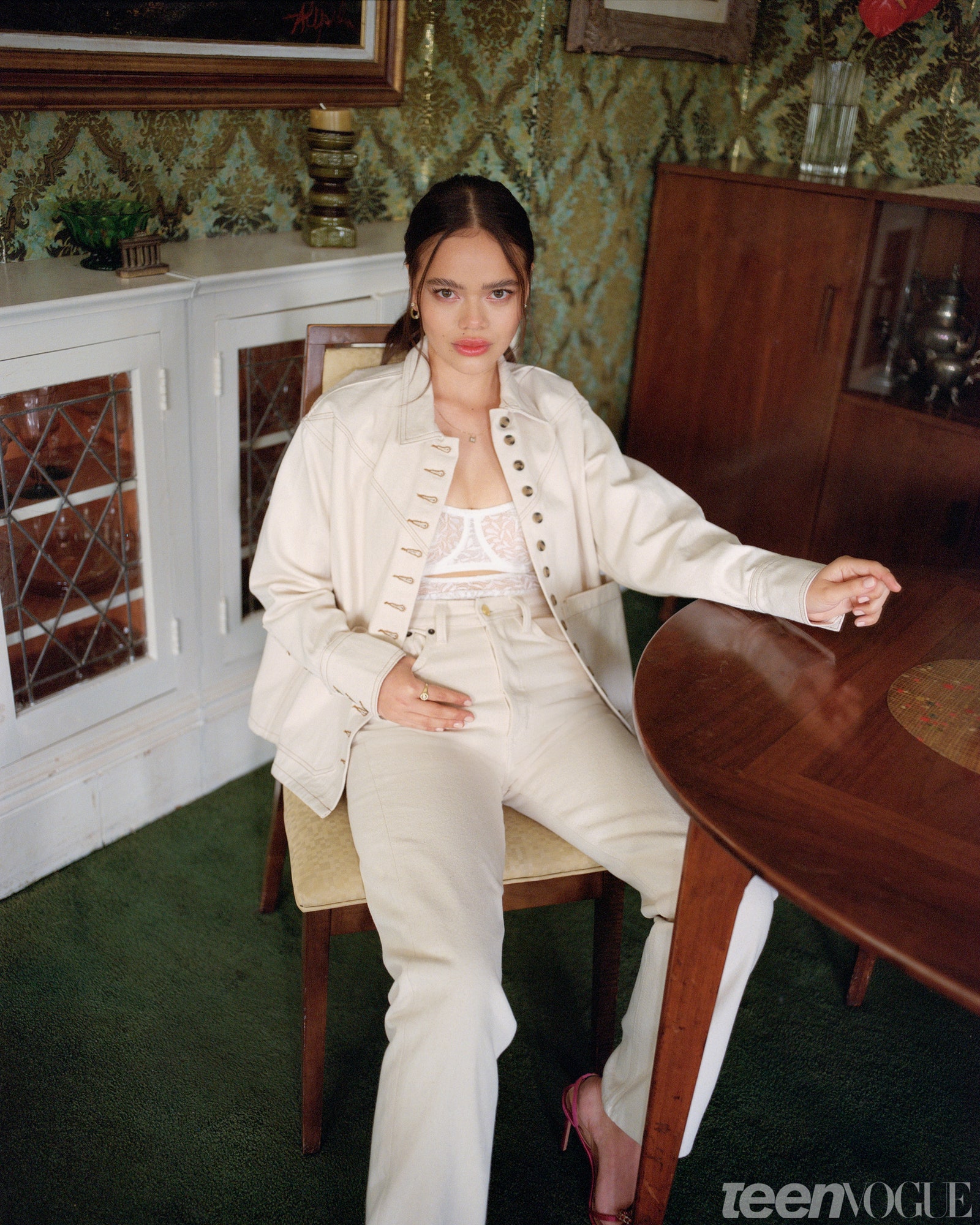 Malia Pyles in a chair inside a midcentury living room