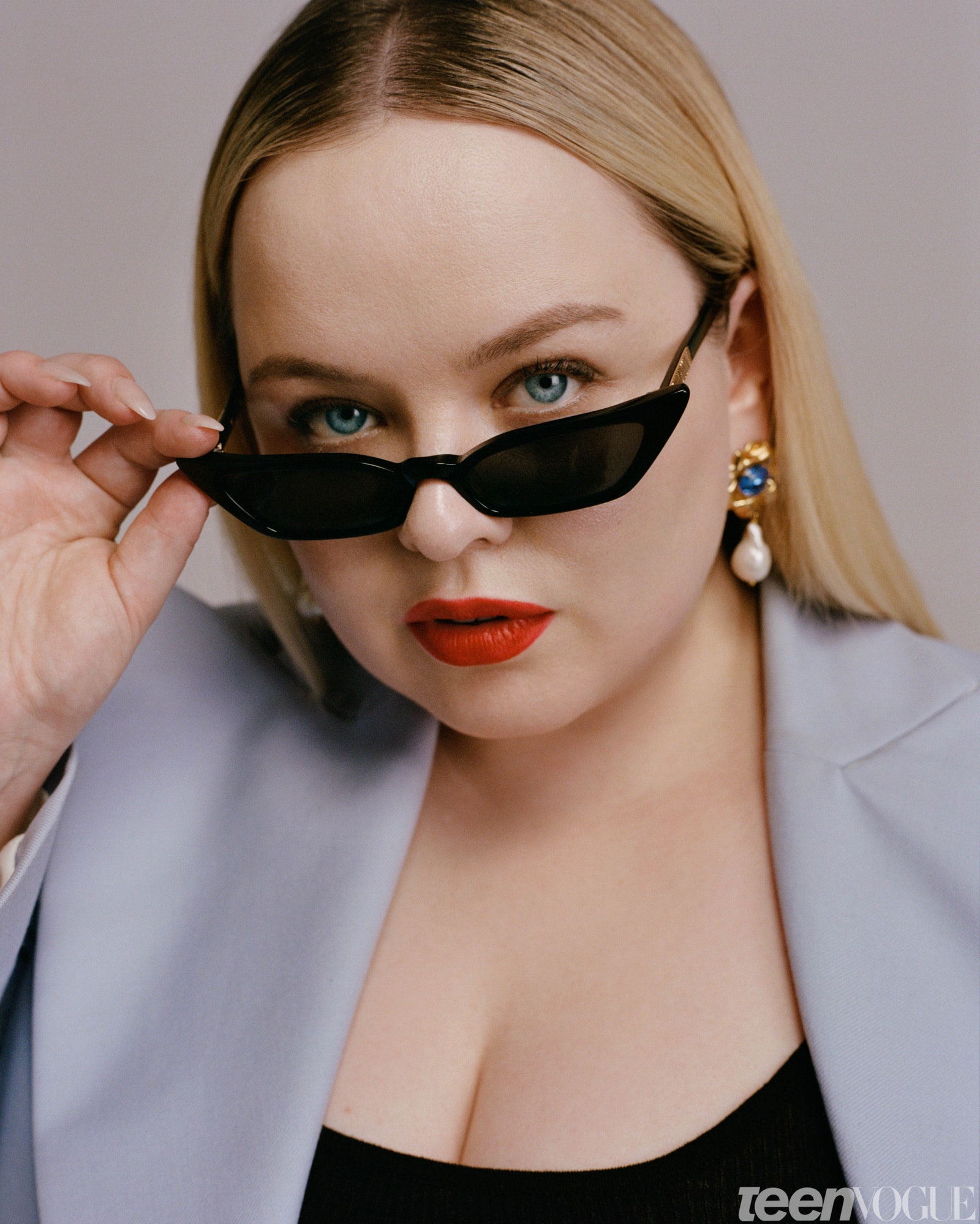 Nicola Coughlan in a blazer with sunglasses perched on nose