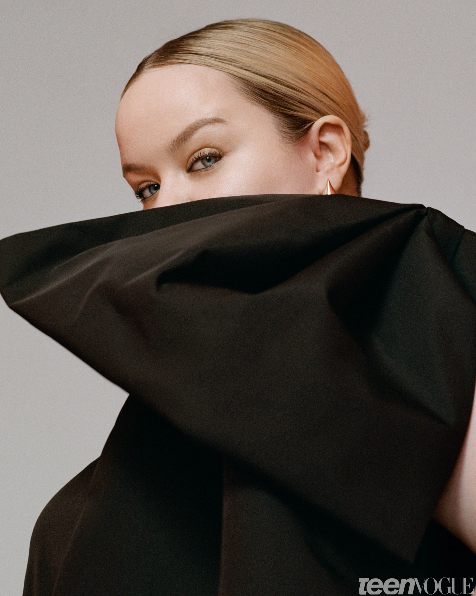 Nicola Coughlan in black with big bow covering half her face