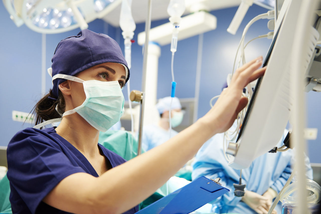 Nurse working with technology in operating room