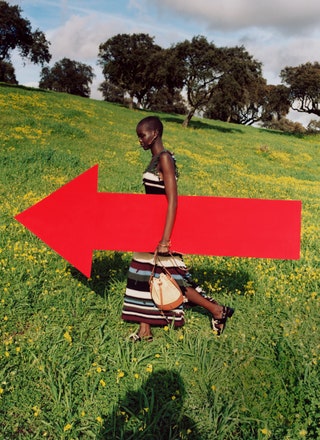 model Adut Akech Salvatore Ferragamo dress nature arrow sign