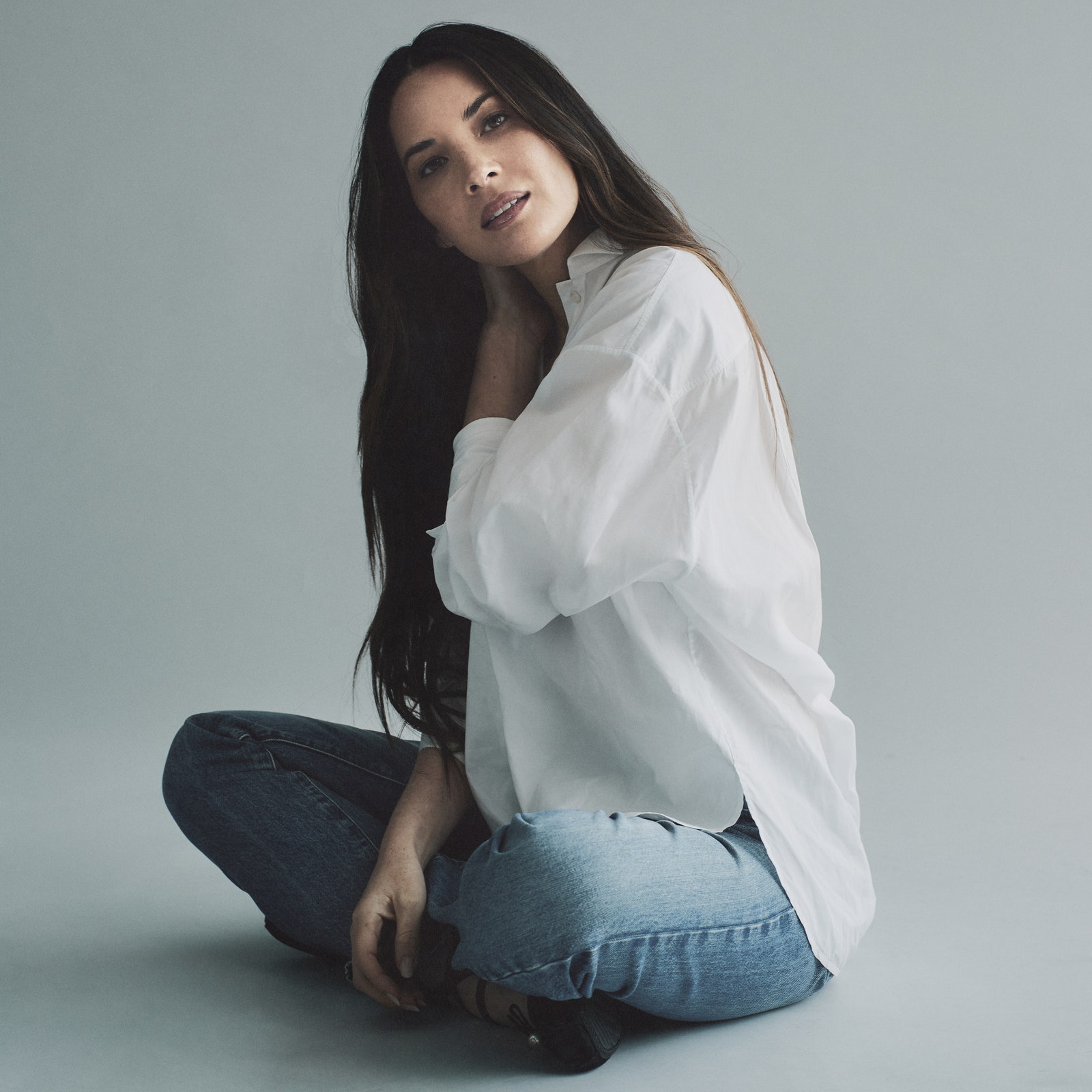 Olivia Munn in a white buttondown shirt and jeans in NYC.