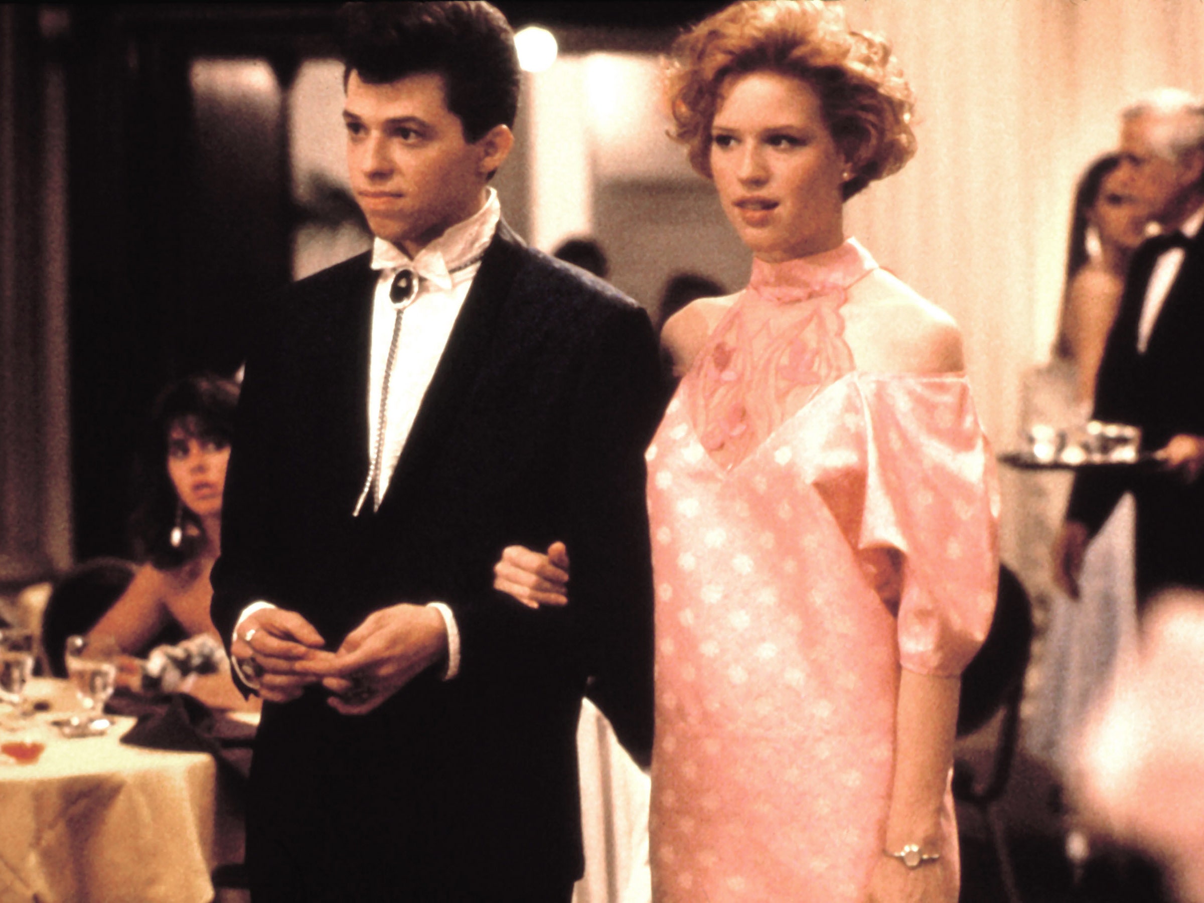 Image may contain Molly Ringwald John Cryer Clothing Formal Wear Suit Person Accessories Jewelry Ring and Adult