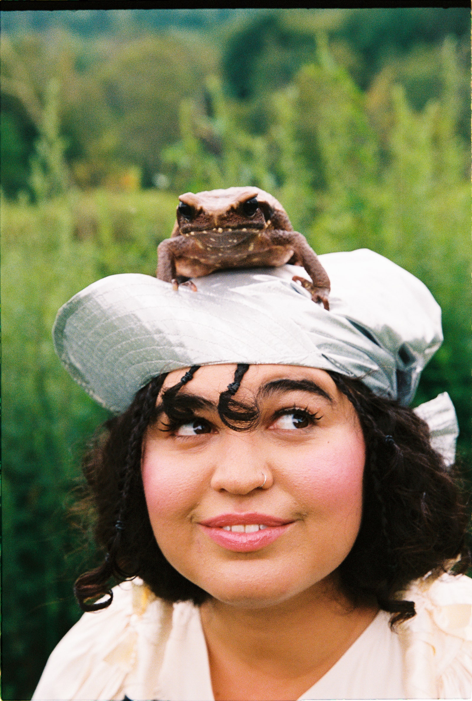 Image may contain Face Head Person Photography Portrait Clothing Hat Cap Adult Happy Smile and Baseball Cap