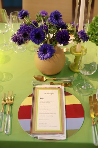 Image may contain Cutlery Furniture Table Dining Table Daisy Flower Plant Fork Glass Flower Arrangement and Purple