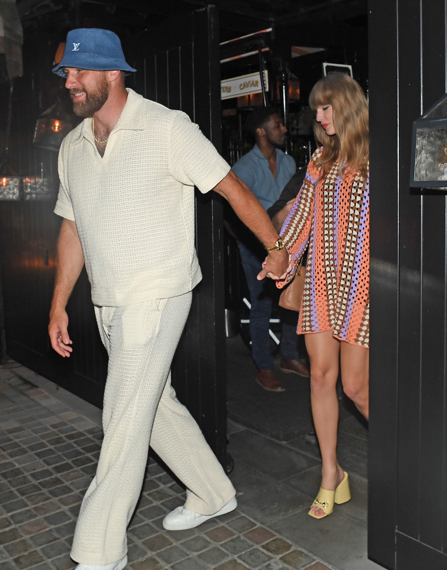 Image may contain Taylor Swift Clothing Footwear Shoe Hat Body Part Hand Person Adult and Holding Hands