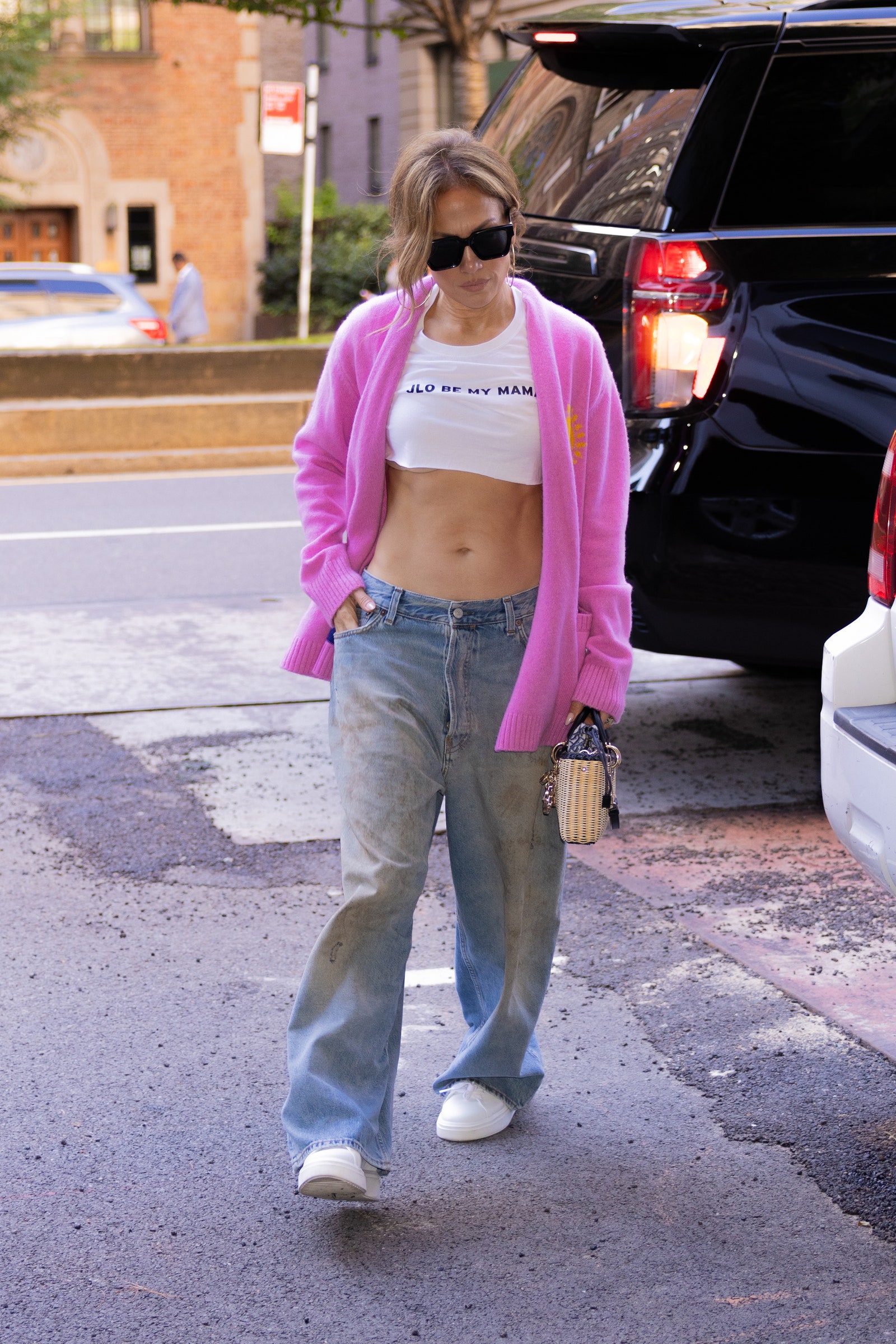 EXCLUSIVE Jennifer Lopez steps out in NYC showing off her abs wearing a “ JLO be my mama “ crop top shirt. She is still...