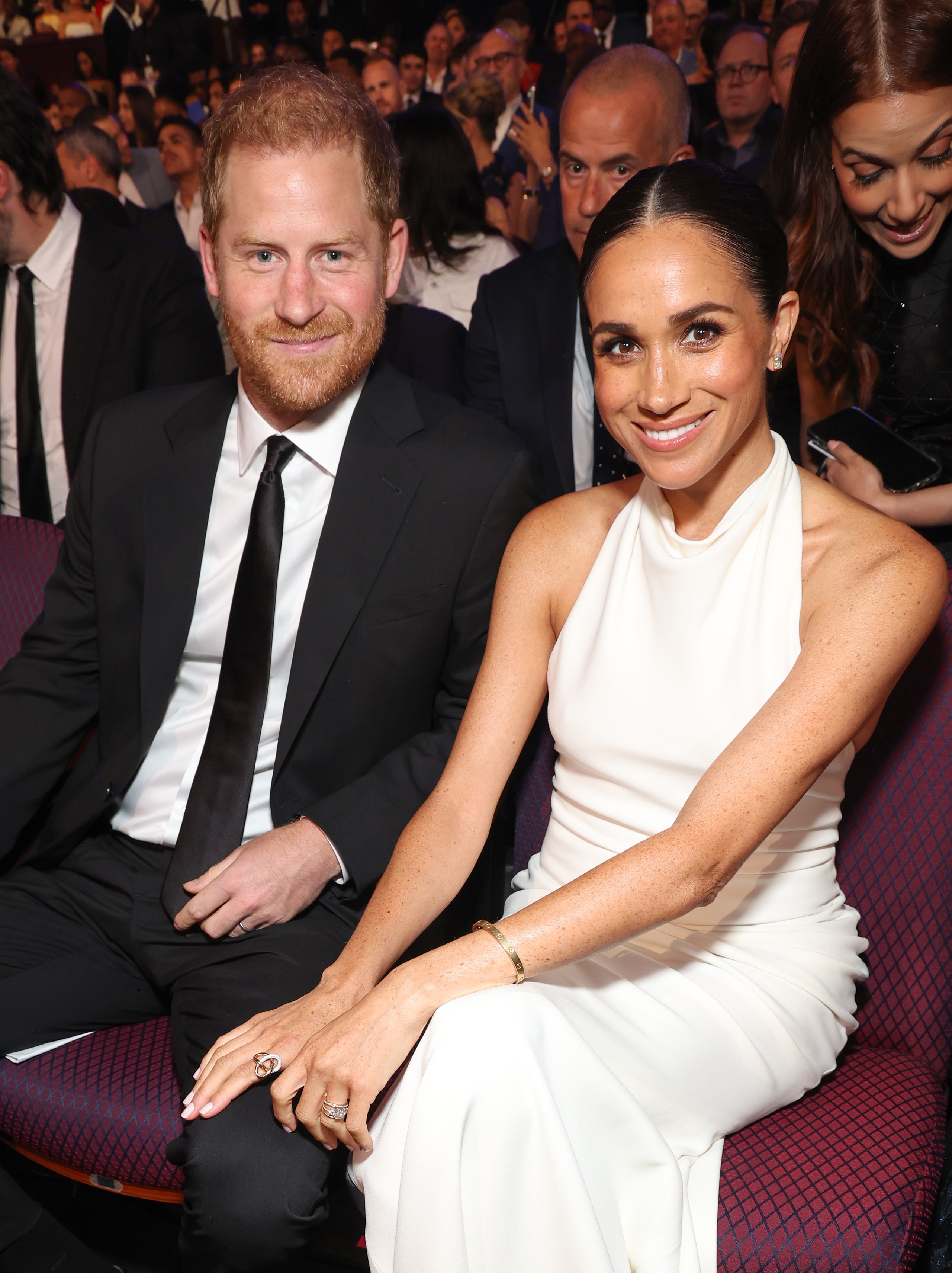 Image may contain Meghan Duchess of Sussex Prince Harry Duke of Sussex Fashion Electronics Mobile Phone and Phone