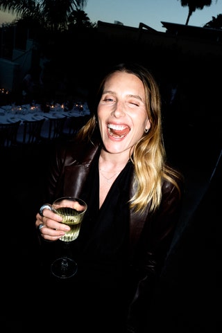 Image may contain Dree Hemingway Face Head Person Photography Portrait Clothing Coat Jacket Cup Glass and Adult