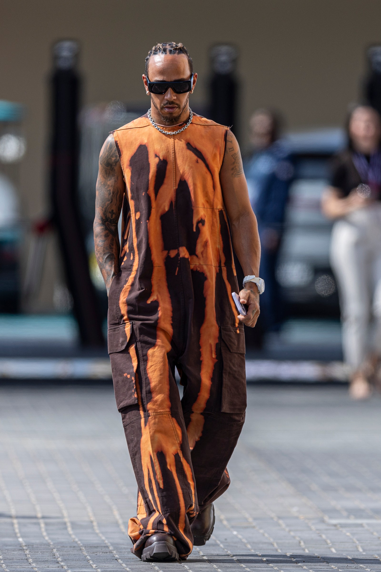 Lewis Hamilton wearing a characteristically directional look walking in the paddock before the final practice ahead of...