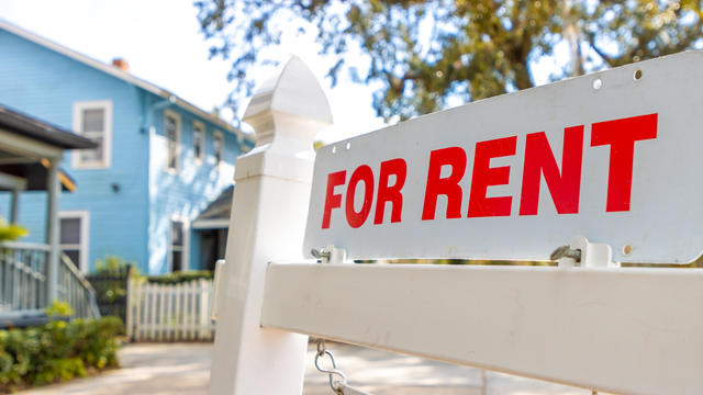 For rent sign in front of house 