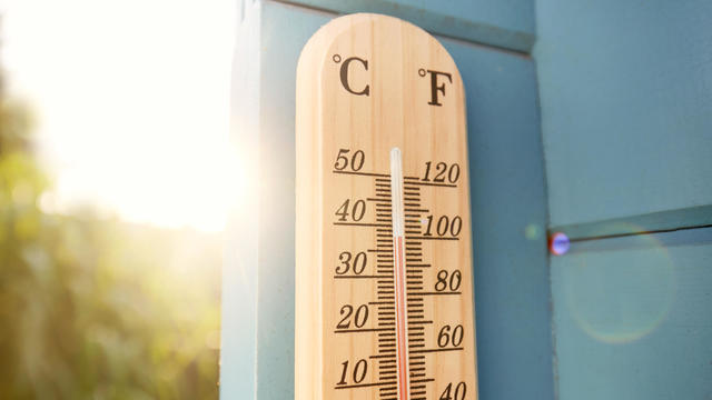 Thermometer against sky and sun 