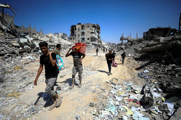 Palestinians inspect damage, after Israeli forces withdrew from Shejaiya neighborhood, in eastern part of Gaza city 