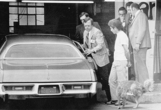 Man Being Lead to Car in Handcuffs 