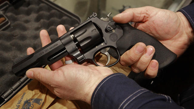 A customer displays the hand giuun he had purchased from Todd Settergren of Setterarms gun shop, on Friday Jan. 13, 2017, in Walnut Creek, Ca. Gun shop owner, Settergren says California gun laws have gone too far and he welcomes the chance that the federa 