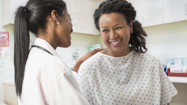 Doctor comforting patient in office 