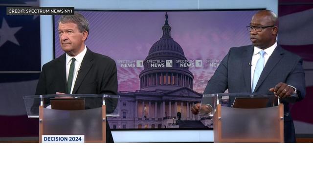 Westchester County Executive George Latimer and Congressman Jamaal Bowman stand behind podiums during a debate. 