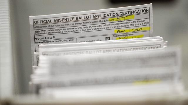 Absentee ballots are seen during a count in Milwaukee on Tuesday, Nov. 8, 2022. 