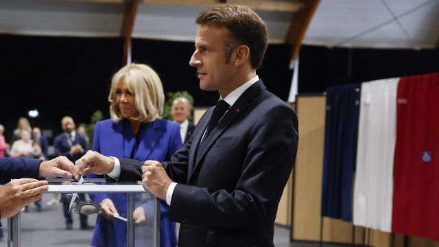 French President Macron votes in the second round of French parliamentary elections 
