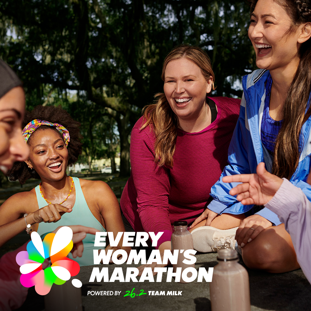 A group of women are our outside talking and getting ready to go for a run together.