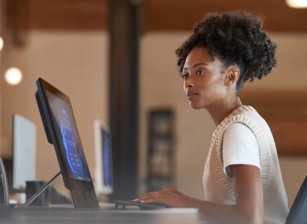 a person sitting at a desk using a computer