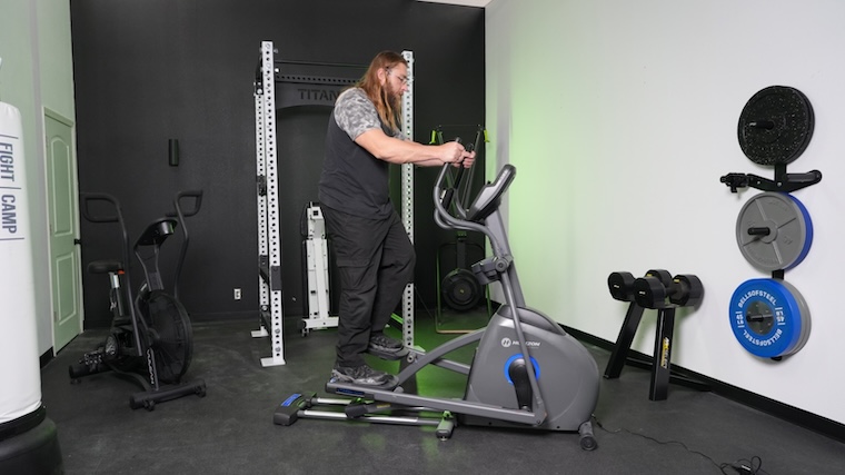 A BarBend tester working out on the Horizon EX-59 elliptical.