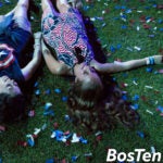 People lie on confetti after the Independence Day celebrations near the Hatch Shell along the Charles River Esplanade.