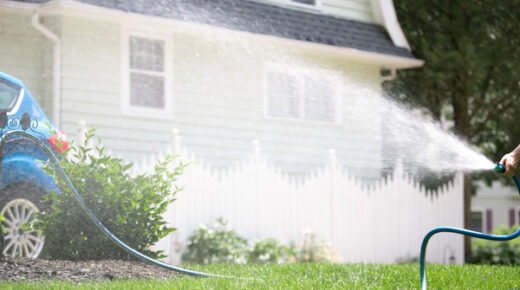 Watering a lawn with a hose.