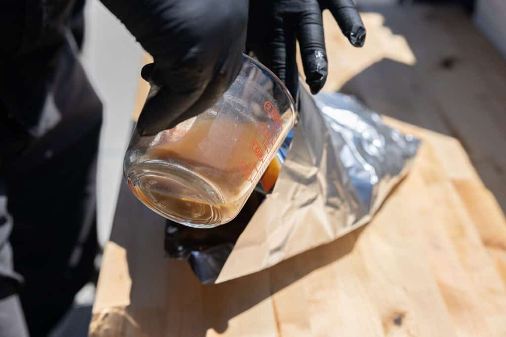 Pouring broth into the brisket