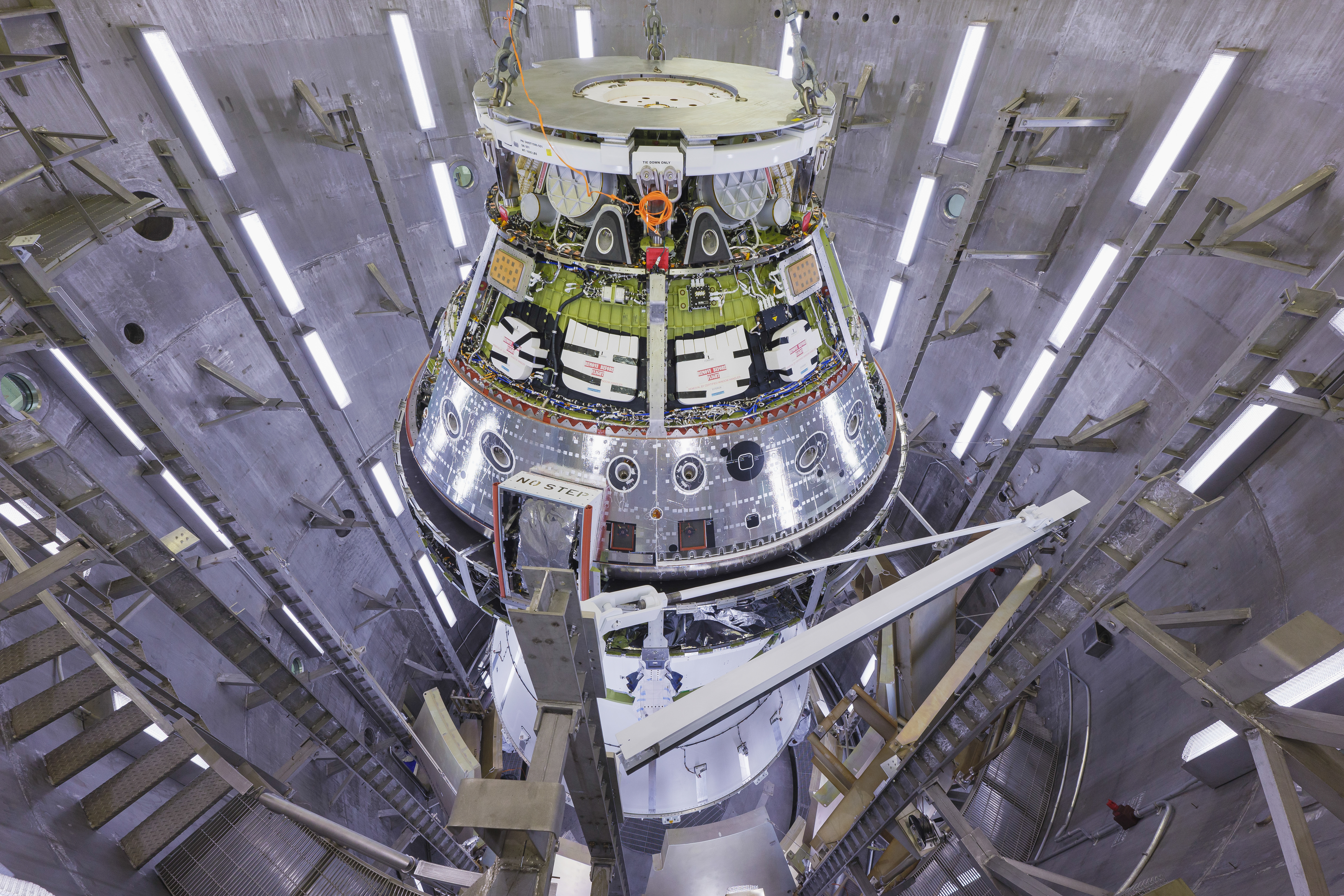 The Artemis II Orion spacecraft is pictured surrounded by the metal walls of the altitude chamber