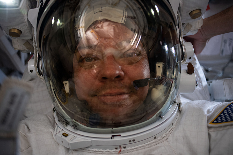 NASA spacewalker Bob Behnken takes a "space-selfie" with his helmet visor up on his U.S. spacesuit.
