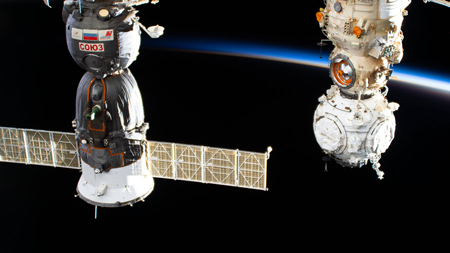 The Soyuz MS-19 crew ship and the Prichal docking module attached to the Nauka multipurpose laboratory module are pictured during an orbital sunset.