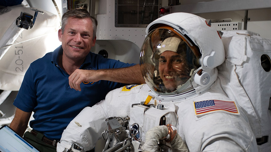 Astronaut Jasmin Moghbeli is suited up testing her spacesuit's components with assistance from astronaut Andreas Mogensen.