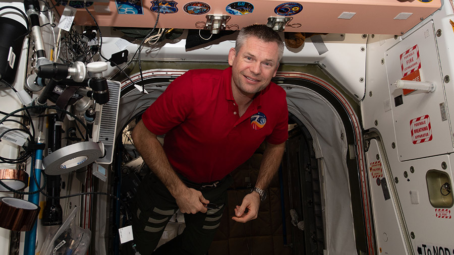 Expedition 70 Commander Andreas Mogensen maneuvers in the vestibule in between the space station's Unity and Tranquility modules.