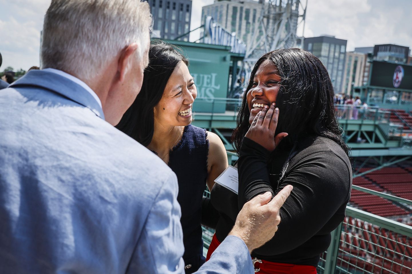 Mayor Michelle Wu laughed with 2024 Valedictorian Christela St. Cyr while attending the Valedictorians Luncheon at Fenway Park on May 28. The annual event recognized and celebrated the 32 top graduates of the Boston Public Schools.