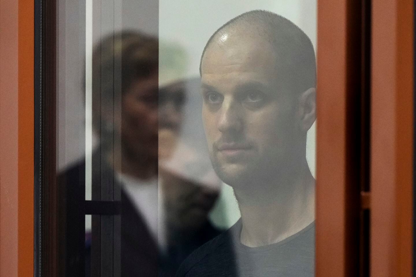 Wall Street Journal reporter Evan Gershkovich stood listening to the verdict in a glass cage of a courtroom inside the building of "Palace of justice," in Yekaterinburg, Russia, on Friday.