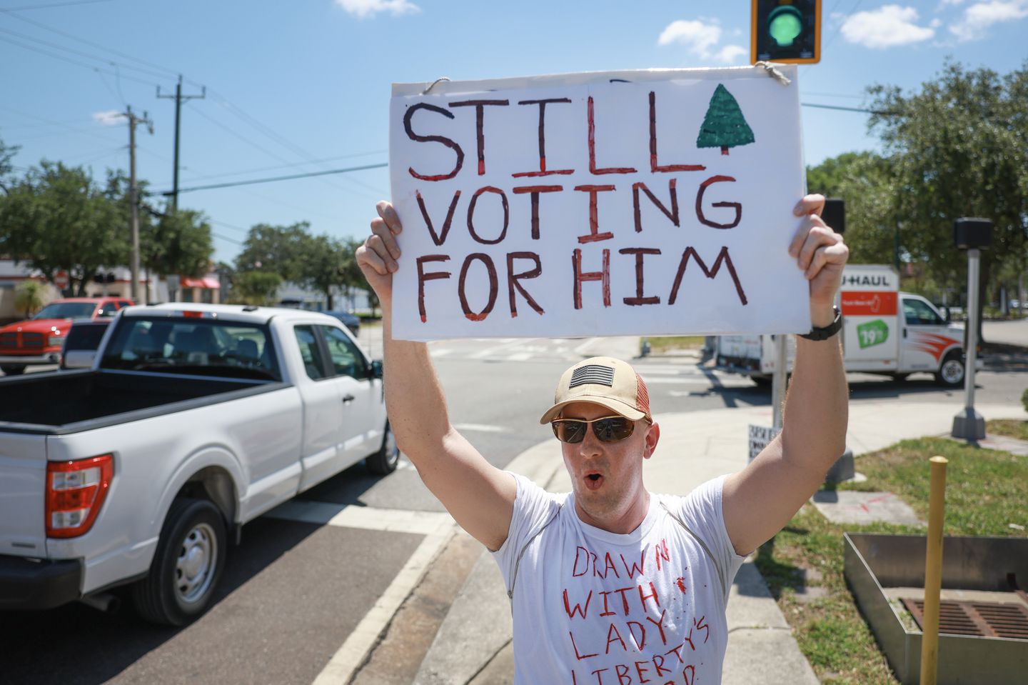 Mark Fuller held a sign that showed his support for former president and convicted felon Donald Trump on May 31, in Titusville, Fla.