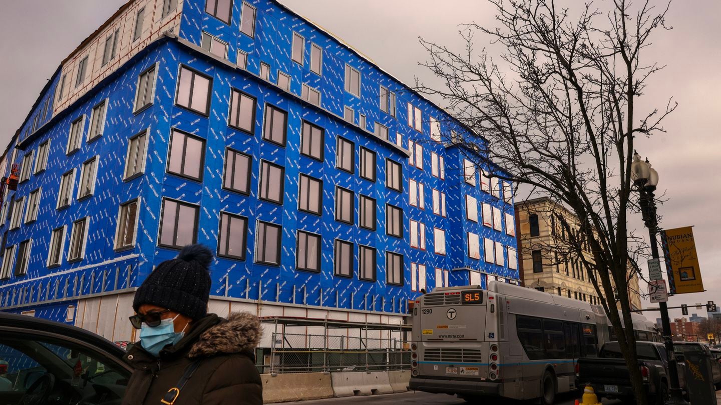 A pedestrian passed a mixed-income housing project in progress at Washington Street in Nubian Square in Roxbury in 2023.