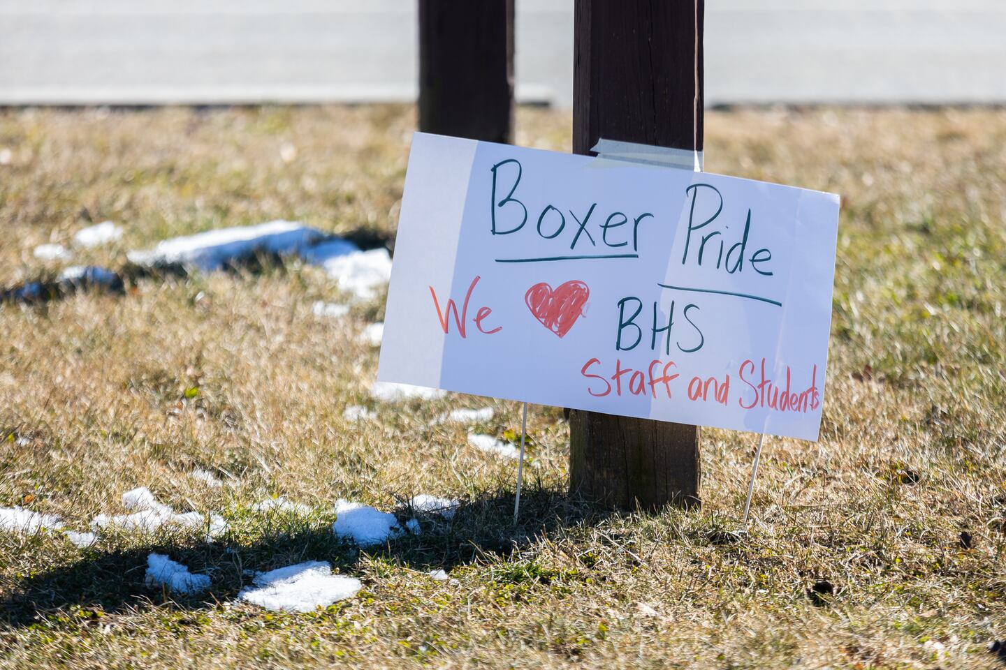 A sign sits on the lawn of Brockton High School, where teachers and staff have been overwhelmed by violence and disciplinary issues.