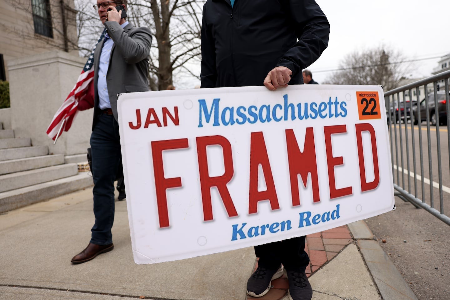 A Karen Read supporter held a sign outside of Norfolk Superior Court following a motions hearing in March.