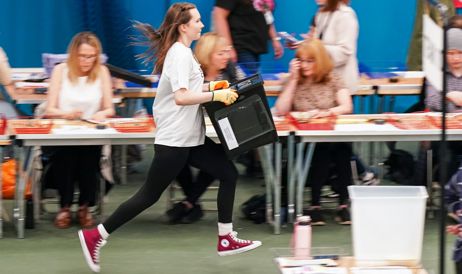 A member of the staff carries a box full of ballot papers at Silksworth Community Pool, Tennis and Wellness Centre in Sunderland - 4 July, 2024